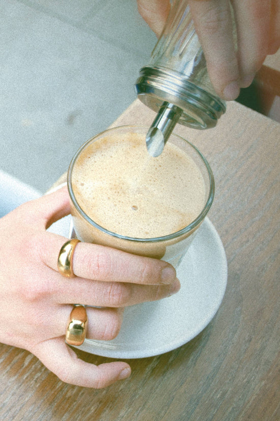 Andrea is wearing our gold Block and Classic rings. Those two rings are made of a high-quality 24 karat gold plating.