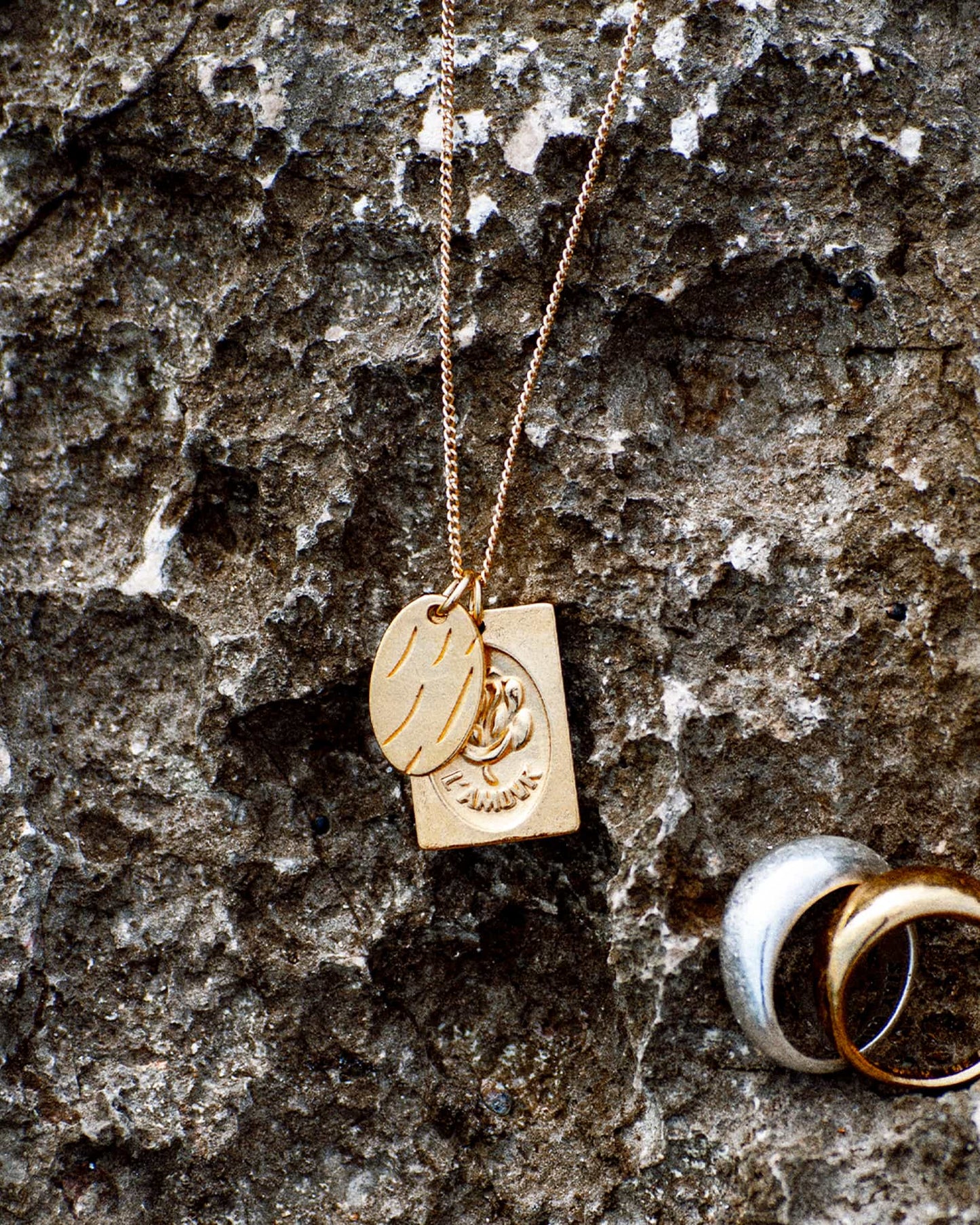 Atelier Domingo's L'Amour necklace is made in Spain. This jewelry is unisex. It is for both men and women.  The pendant is made of a high-quality 24 karat gold plating. The cuban chain is made of solid 925 Sterling silver with a high-quality 18 karat gold plating.