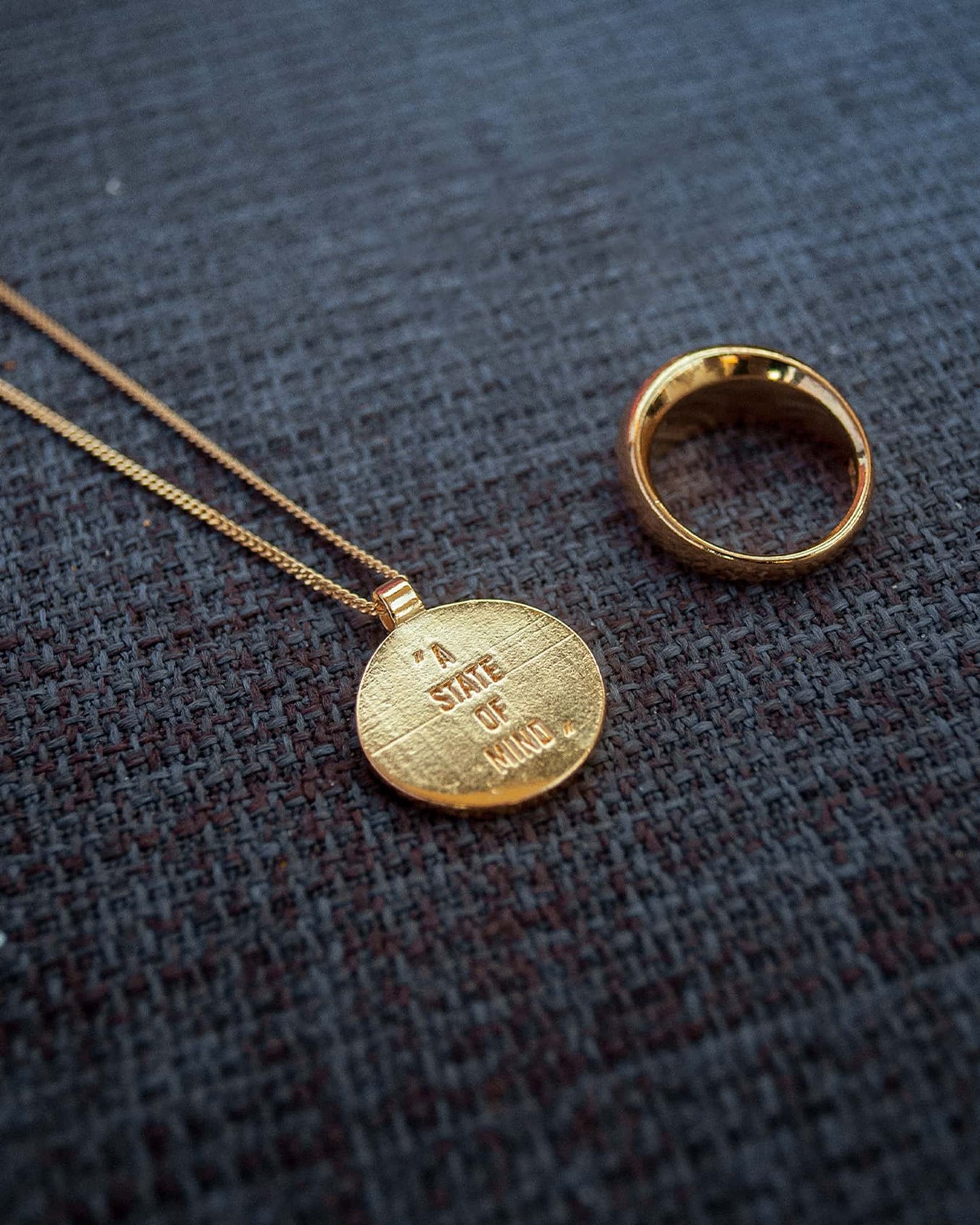Atelier Domingo's State of Mind gold necklace is designed in France and made in Spain. This necklace is unisex, made for both men and women. The pendant is made of a high-quality 24 karat gold plating. The cuban chain is made of solid 925 Sterling silver with a high-quality 18 karat gold plating.