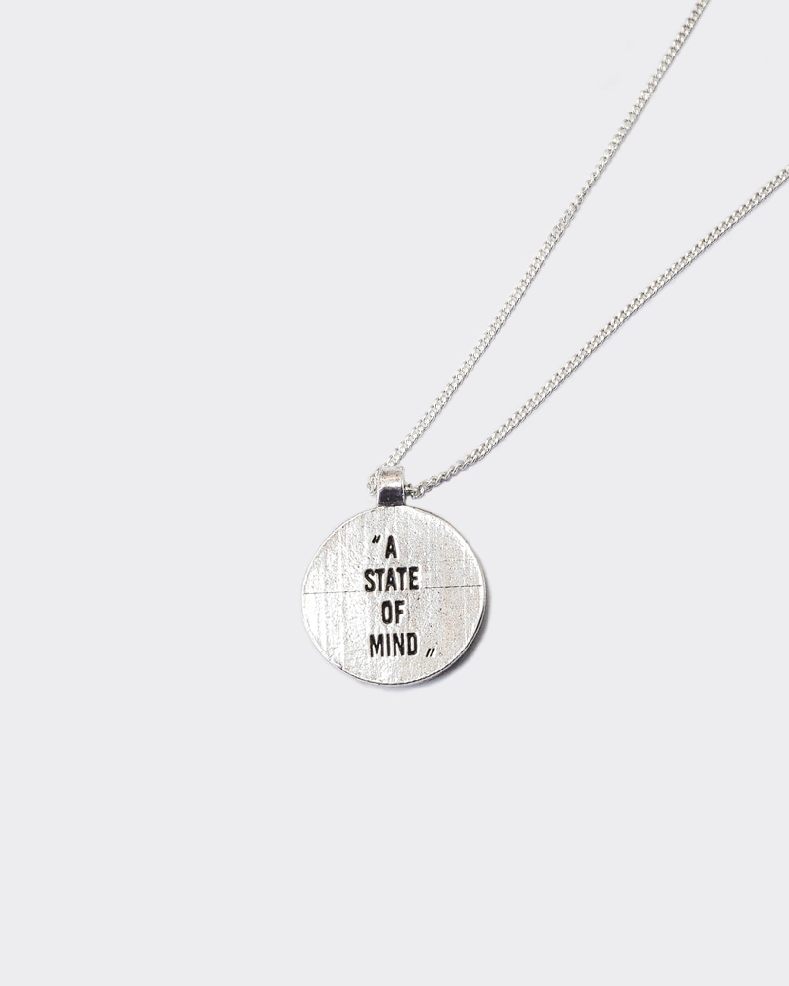 Atelier Domingo's State of Mind silver necklace is designed in France and made in Spain. This necklace is unisex, made for both men and women. The pendant is made of a high-quality 925 Sterling silver plating. The cuban chain is made of solid 925 Sterling silver.