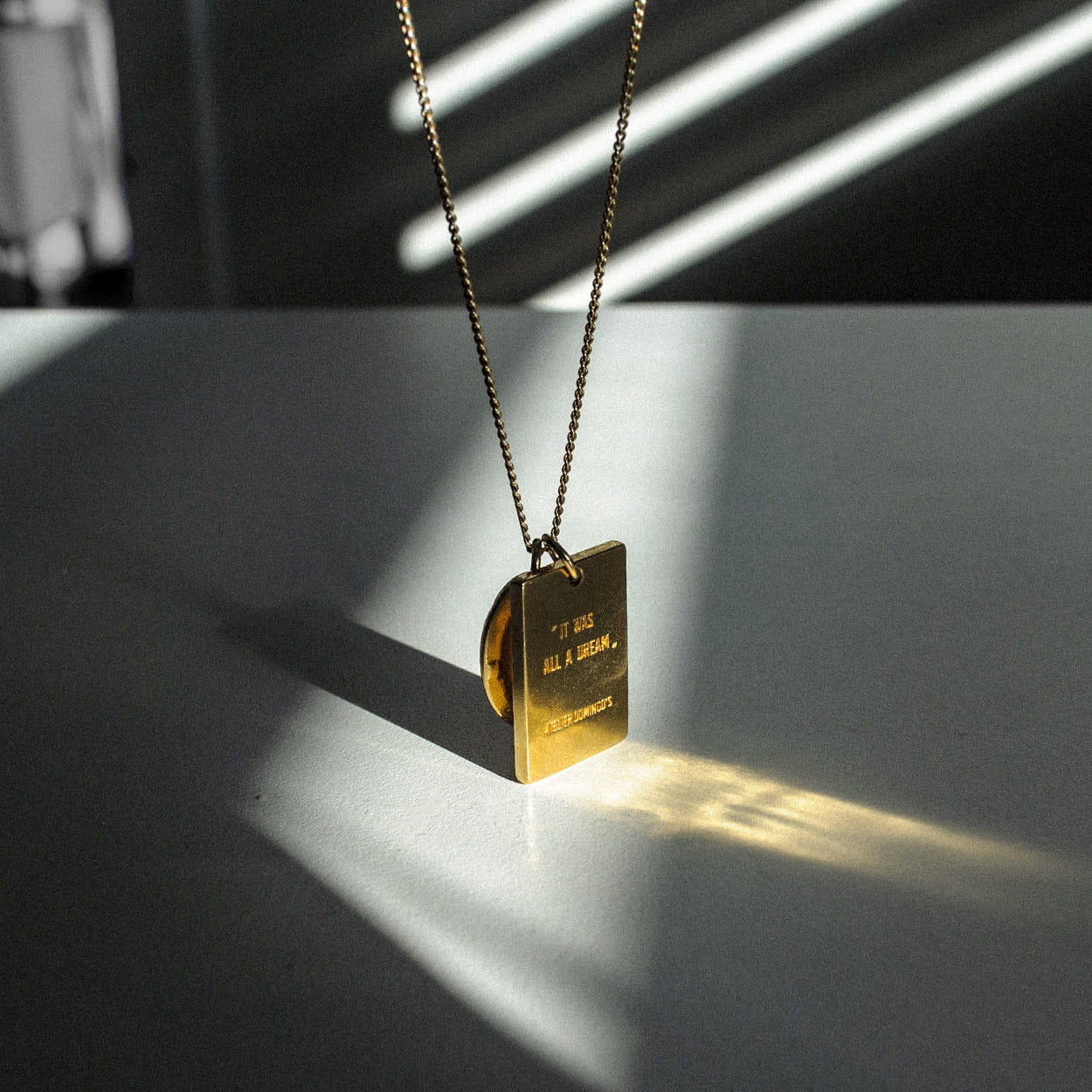 Atelier Domingo's L'Amour necklace is made in Spain. This jewelry is unisex. It is for both men and women. The pendant is made of a high-quality 24 karat gold plating. The cuban chain is made of solid 925 Sterling silver with a high-quality 18 karat gold plating.