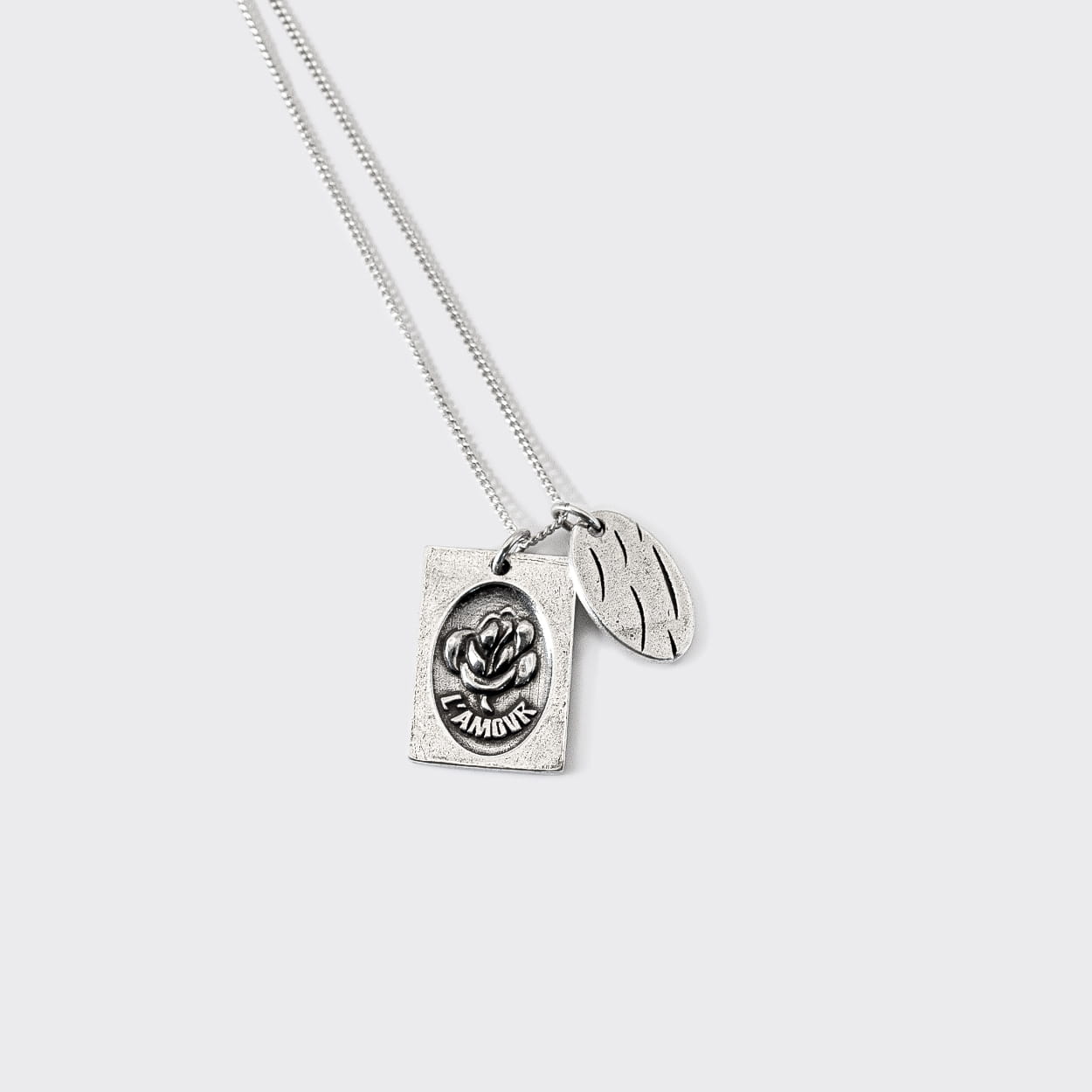 Atelier Domingo's L'Amour silver necklace is made in Spain. It is a unisex jewelry, made for both men and women. The pendant is made of a high-quality 925 Sterling silver plating (10 microns). The cuban chain is made of solid 925 Sterling silver.