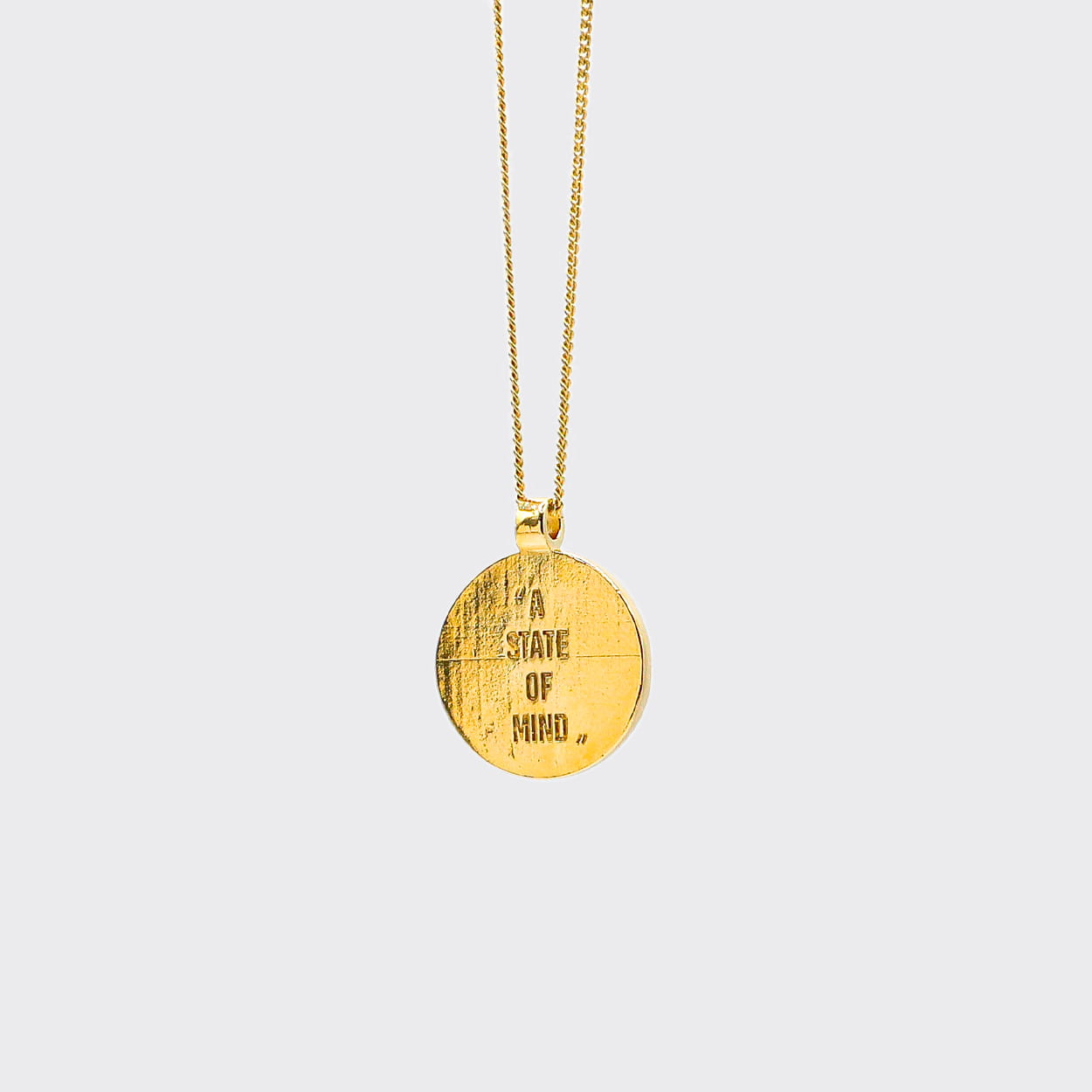 Atelier Domingo's State of Mind gold necklace is designed in France and made in Spain. This necklace is unisex, made for both men and women. The pendant is made of a high-quality 24 karat gold plating. The cuban chain is made of solid 925 Sterling silver with a high-quality 18 karat gold plating.