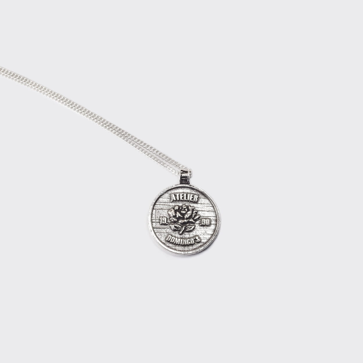 Atelier Domingo's State of Mind silver necklace is designed in France and made in Spain. This necklace is unisex, made for both men and women. The pendant is made of a high-quality 925 Sterling silver plating. The cuban chain is made of solid 925 Sterling silver.