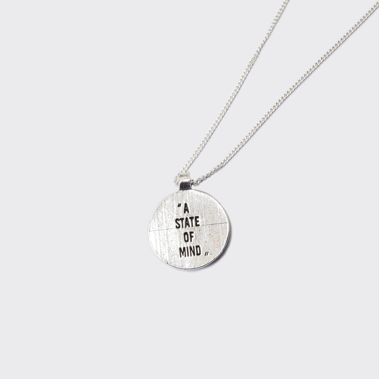 Atelier Domingo's State of Mind silver necklace is designed in France and made in Spain. This necklace is unisex, made for both men and women. The pendant is made of a high-quality 925 Sterling silver plating. The cuban chain is made of solid 925 Sterling silver.
