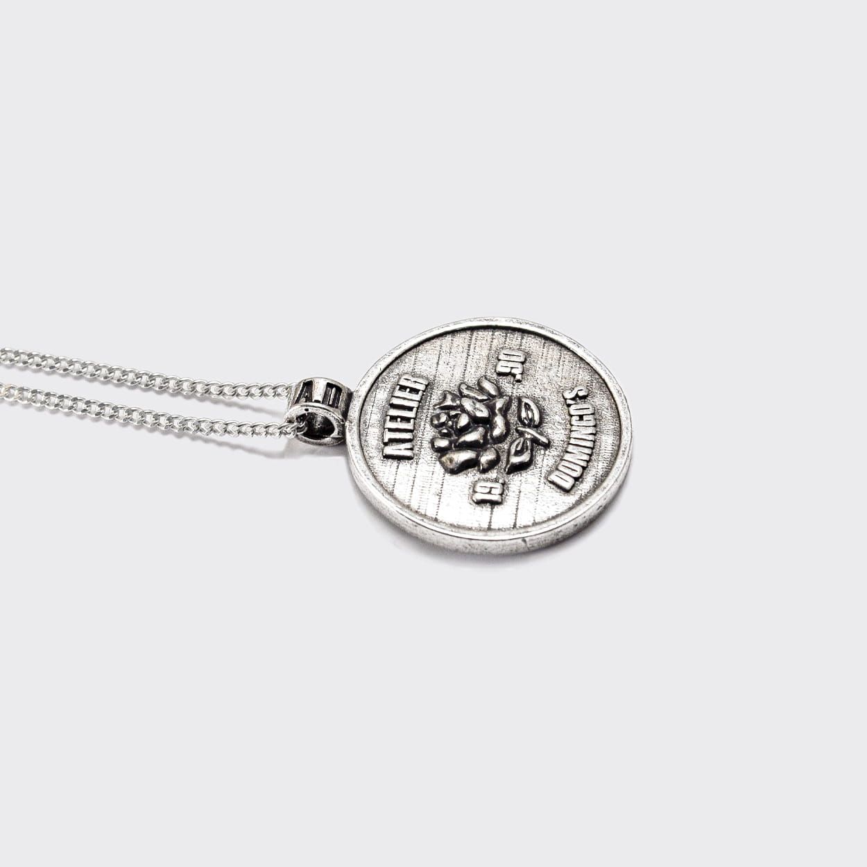 Atelier Domingo's State of Mind silver necklace is designed in France and made in Spain. This necklace is unisex, made for both men and women. The pendant is made of a high-quality 925 Sterling silver plating. The cuban chain is made of solid 925 Sterling silver.