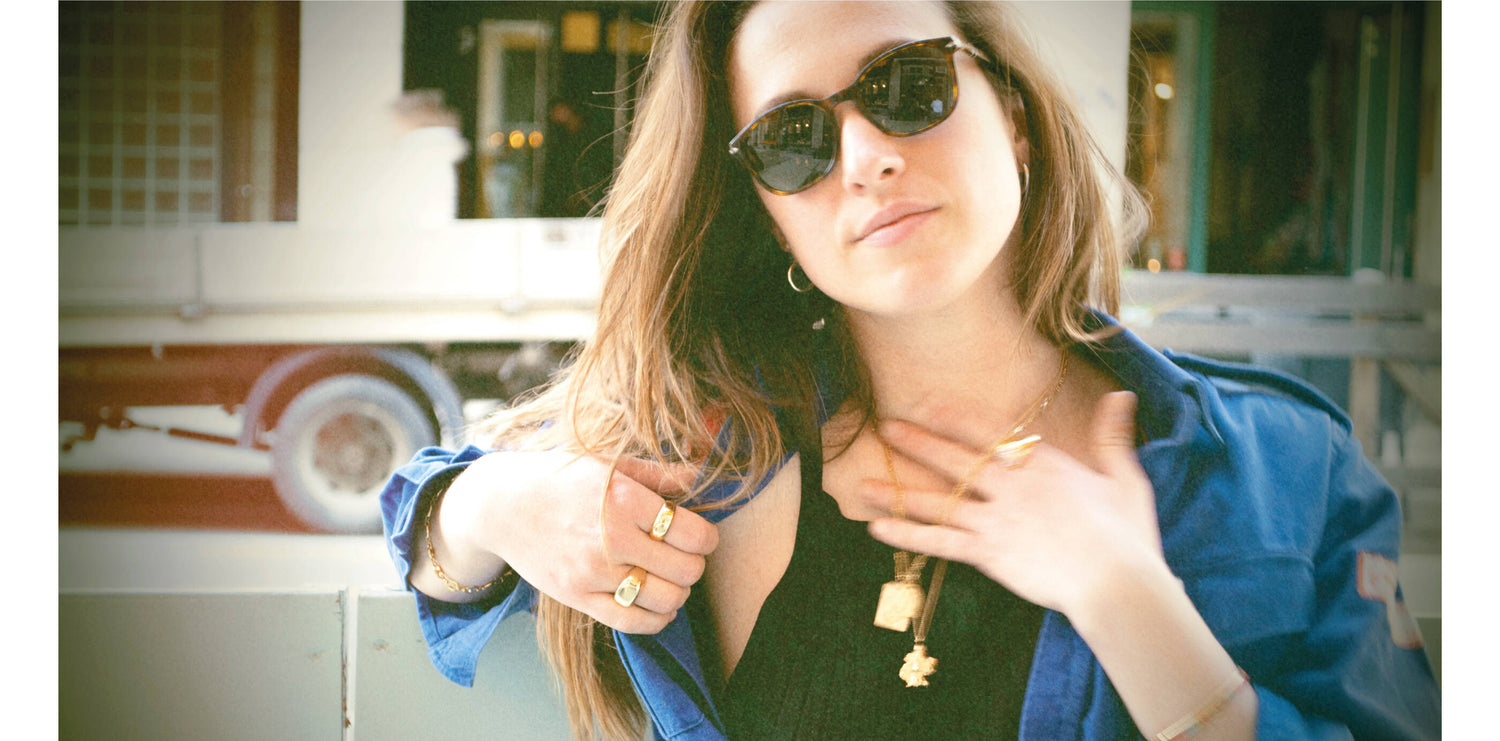 Andrea is wearing our gold Brooklyn necklace. She also wears L'Amour necklace and a few of our gold signet rings. All our gold jewelry are made of a high-quality 24 karat gold plating.