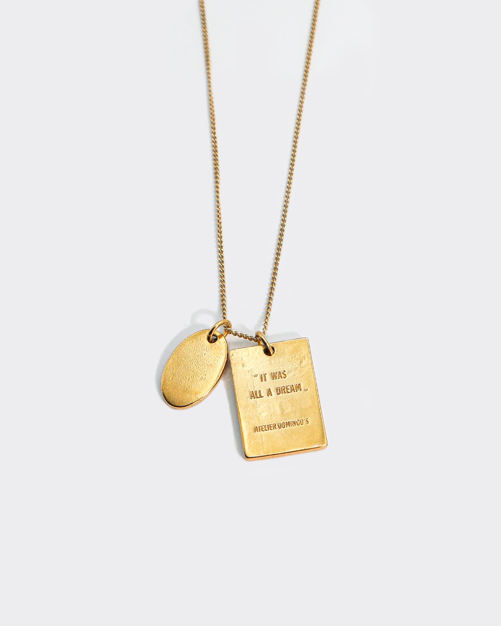 Atelier Domingo's L'Amour necklace is made in Spain. This jewelry is unisex. It is for both men and women.  The pendant is made of a high-quality 24 karat gold plating. The cuban chain is made of solid 925 Sterling silver with a high-quality 18 karat gold plating.