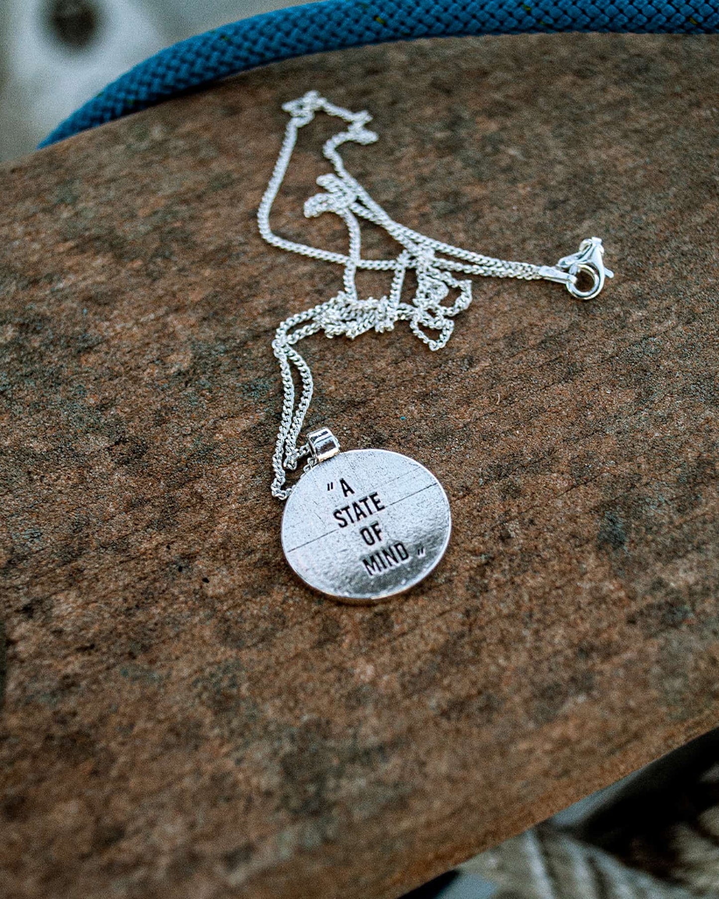 Atelier Domingo's State of Mind silver necklace is designed in France and made in Spain. This necklace is unisex, made for both men and women. The pendant is made of a high-quality 925 Sterling silver plating. The cuban chain is made of solid 925 Sterling silver.