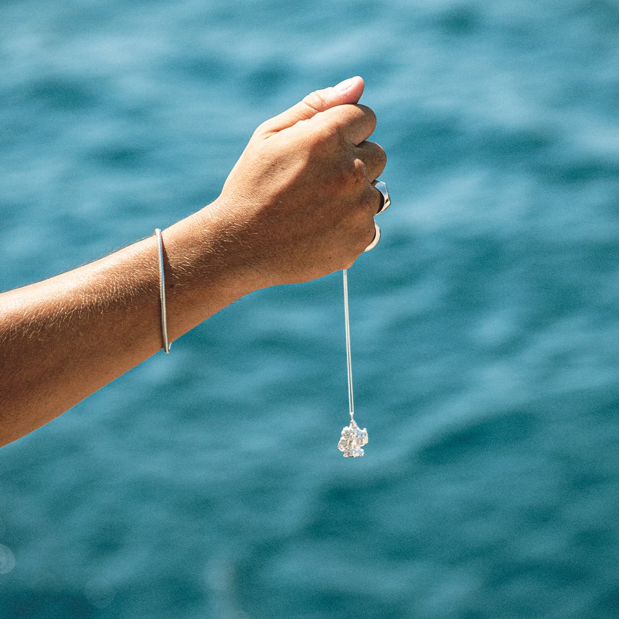 Atelier Domingo's Brooklyn necklace recalls a gold nugget. The pendant is made of a high-quality 925 Sterling silver plating (10 microns). The cuban chain is made of solid 925 sterling silver. This necklace is unisex, made in Spain for both men and women.