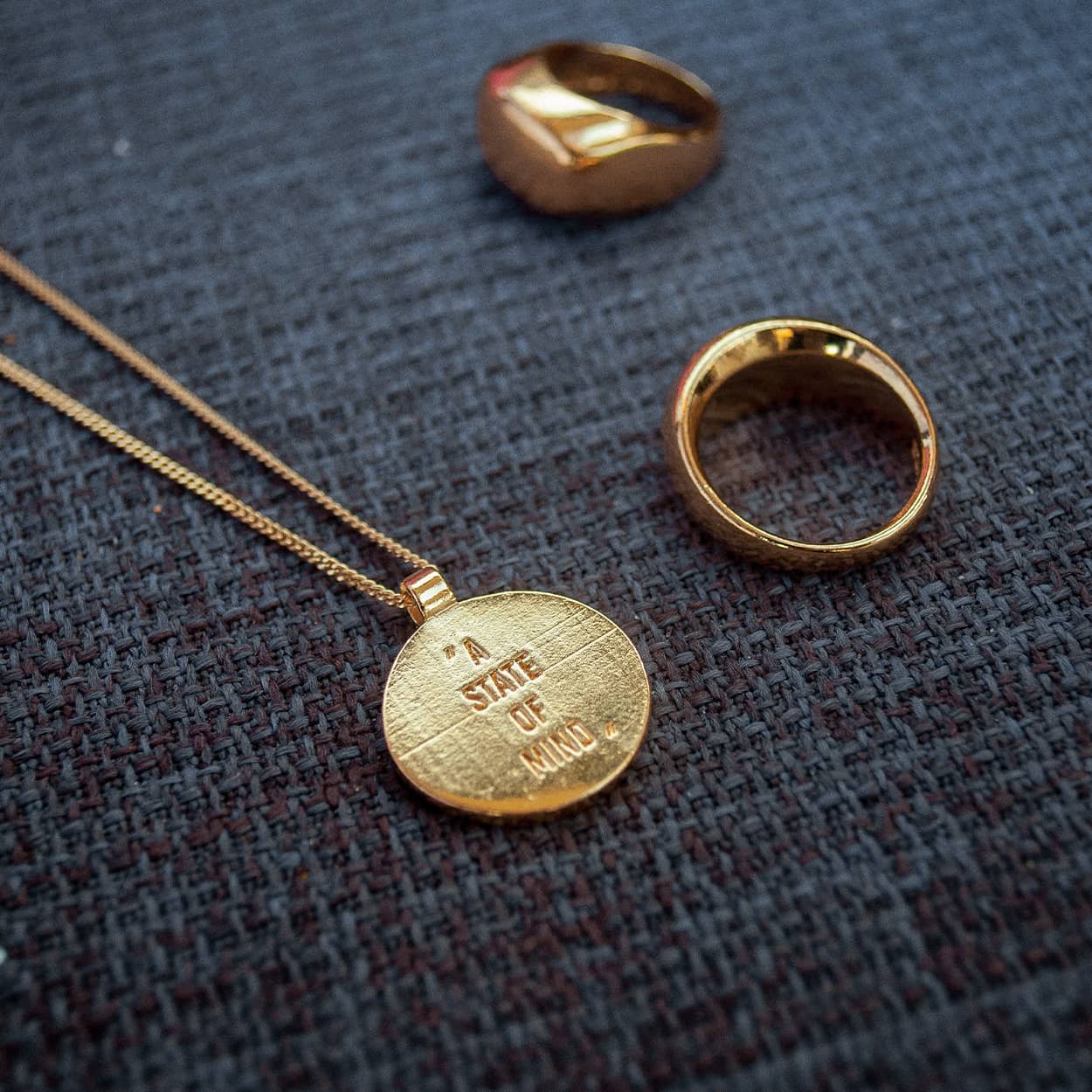 Atelier Domingo's State of Mind gold necklace is designed in France and made in Spain. This necklace is unisex, made for both men and women. The pendant is made of a high-quality 24 karat gold plating. The cuban chain is made of solid 925 Sterling silver with a high-quality 18 karat gold plating.