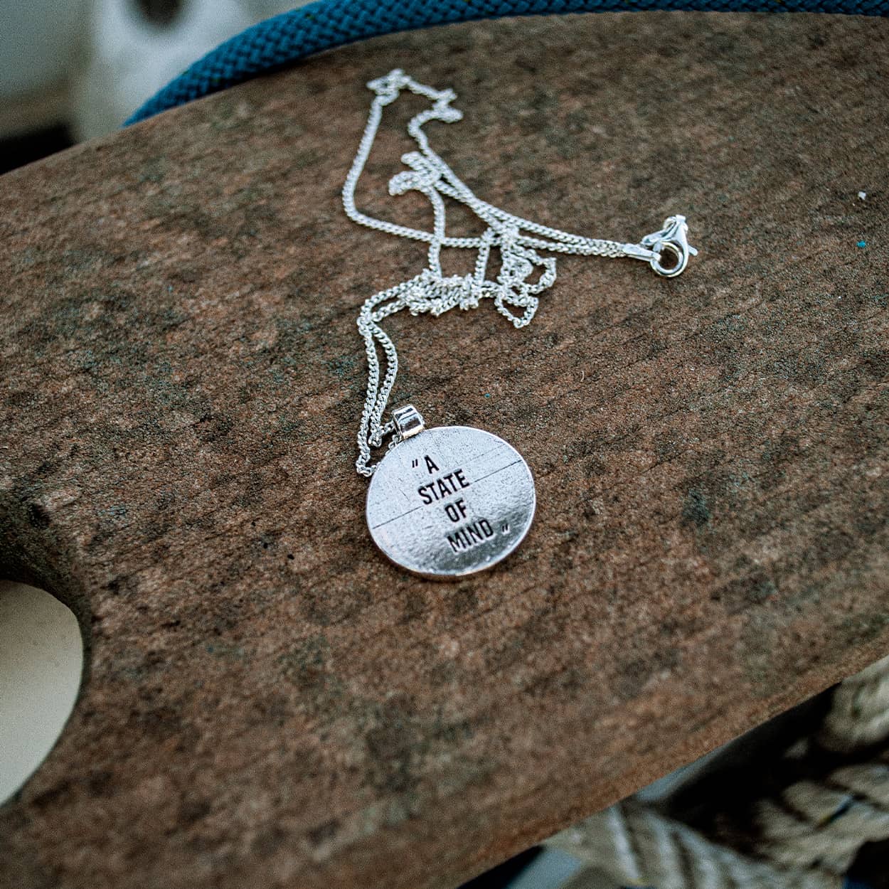 Atelier Domingo's State of Mind silver necklace is designed in France and made in Spain. This necklace is unisex, made for both men and women. The pendant is made of a high-quality 925 Sterling silver plating. The cuban chain is made of solid 925 Sterling silver.